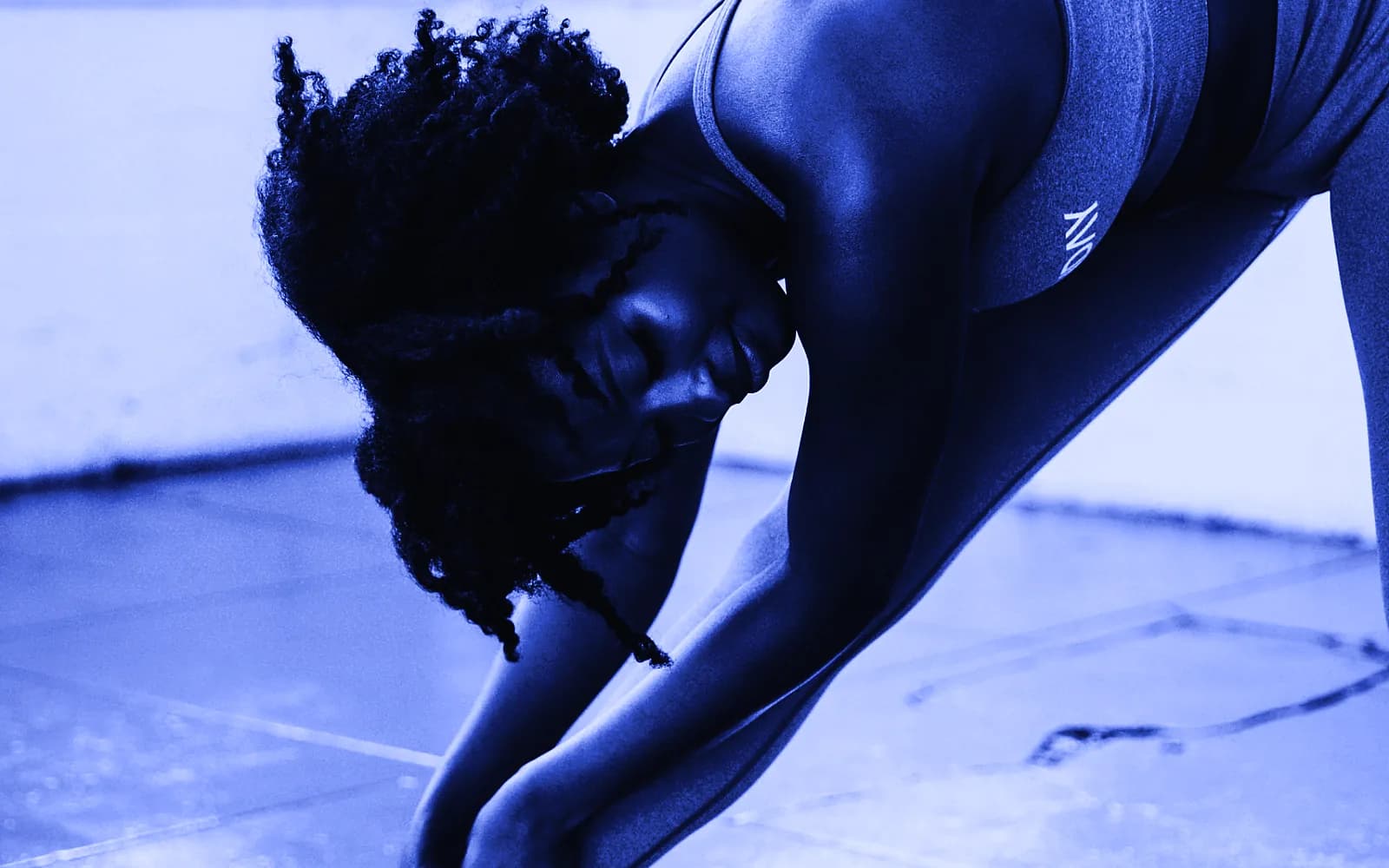 A woman stretching during a workout