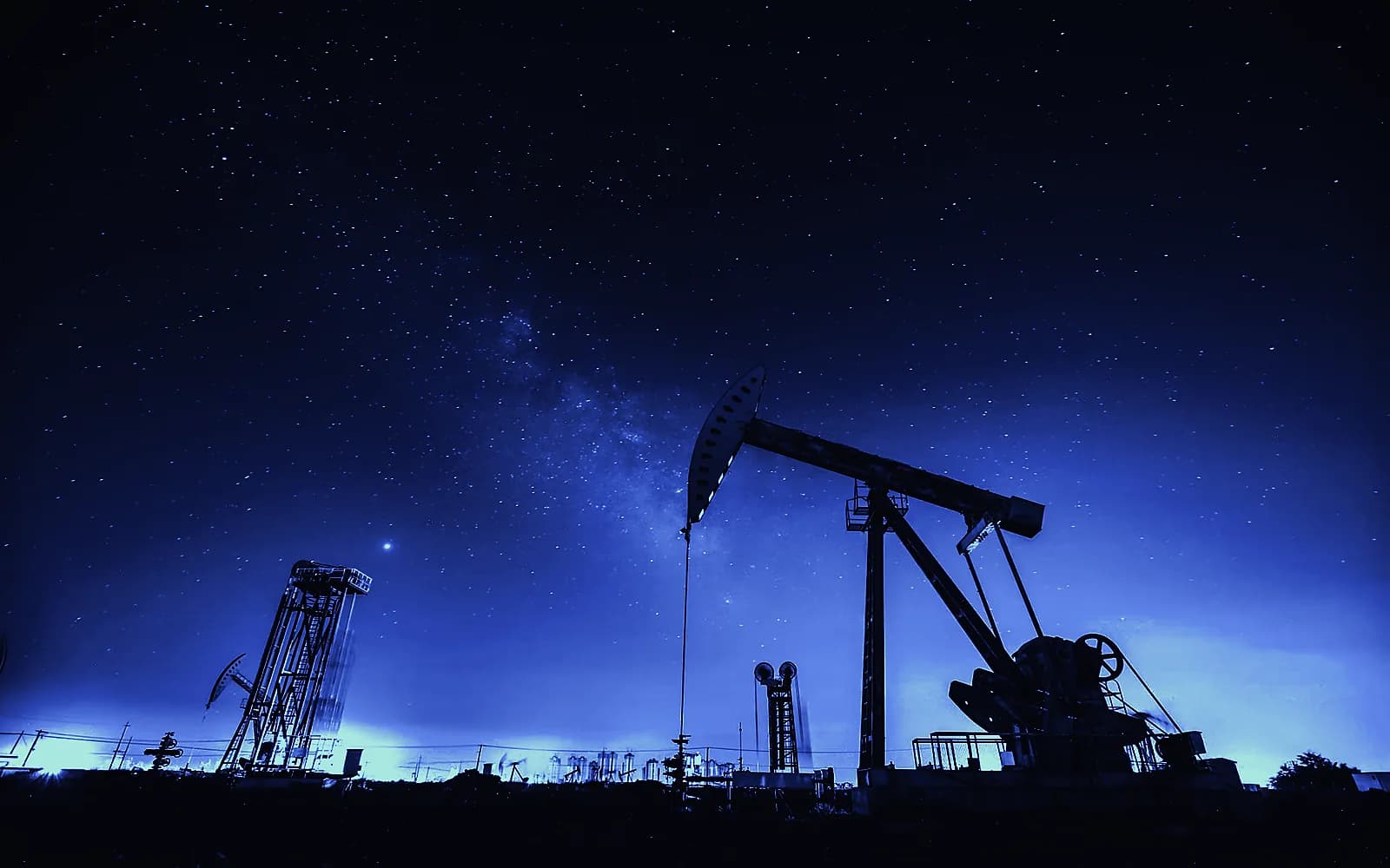 Oil pump jack against a night sky